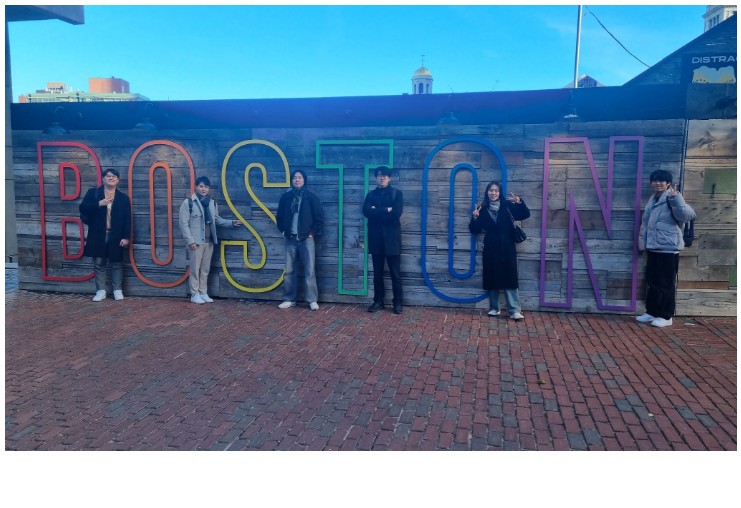 Group photo in front of a Boston sign during the MRS meeting