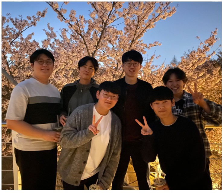 Group photo under cherry blossoms celebrating a Ministry of Education fellowship